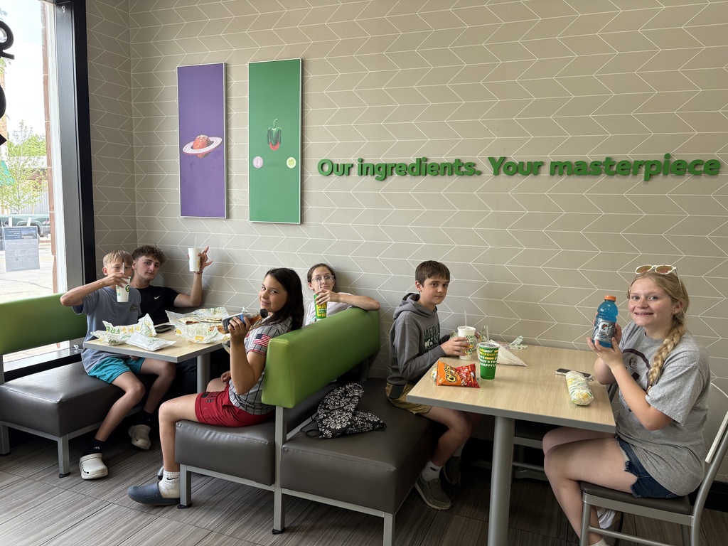 group of students eating lunch at subway.