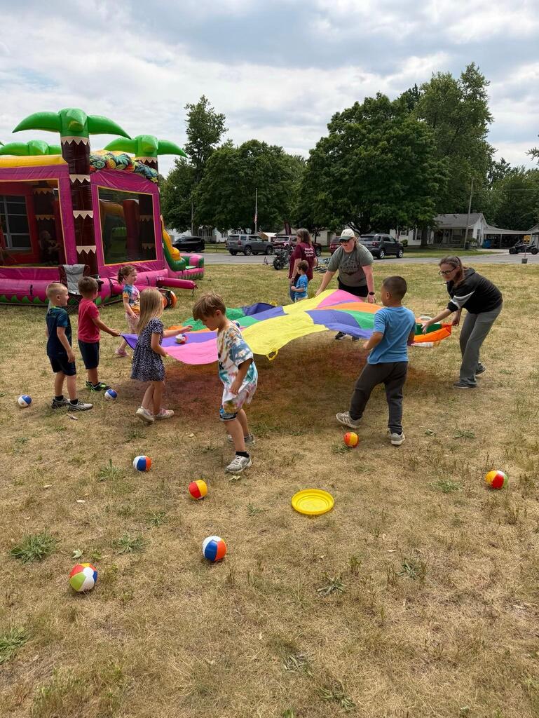 students playing with parachute