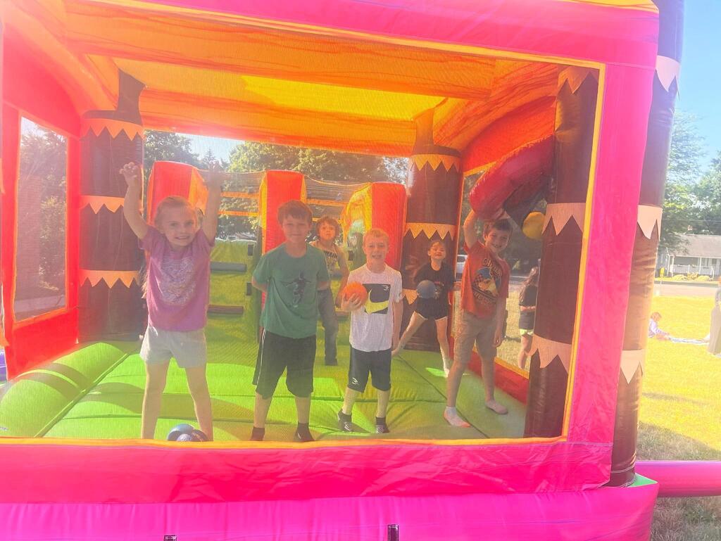 student jumping in bounce hosue