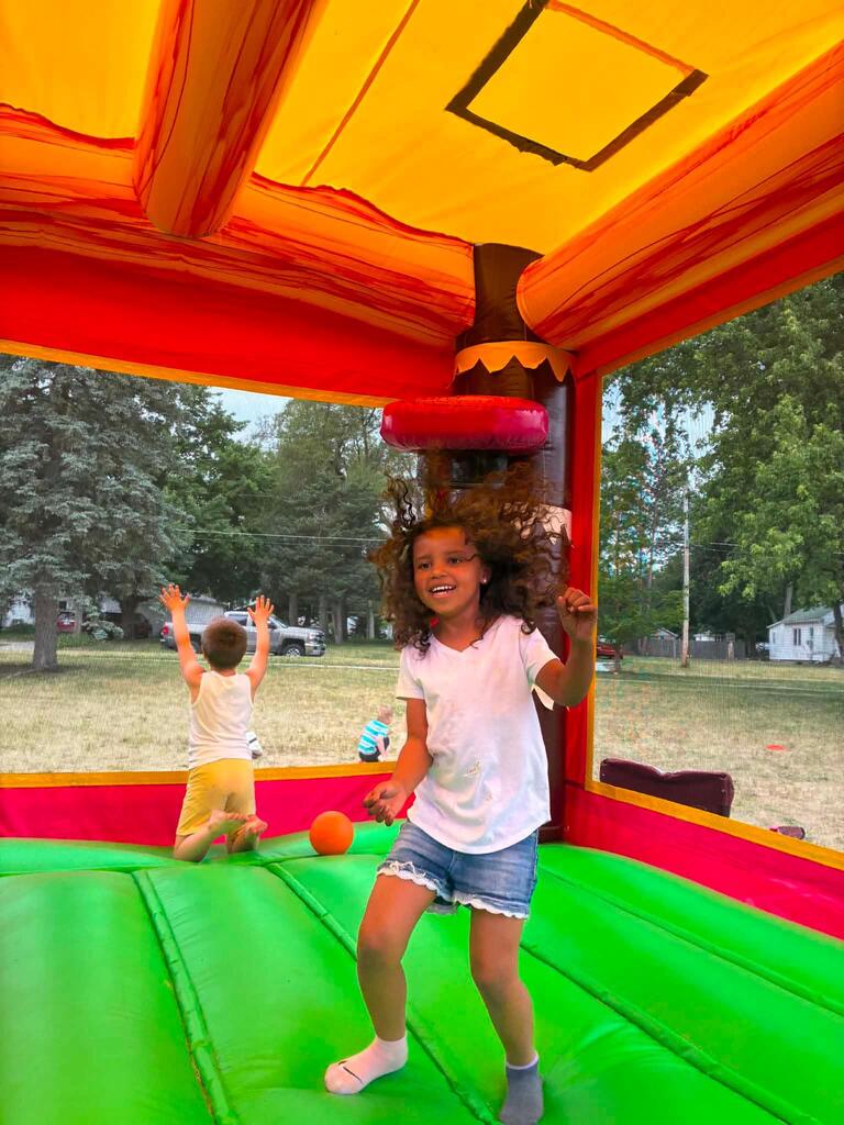 student jumping in bounce house