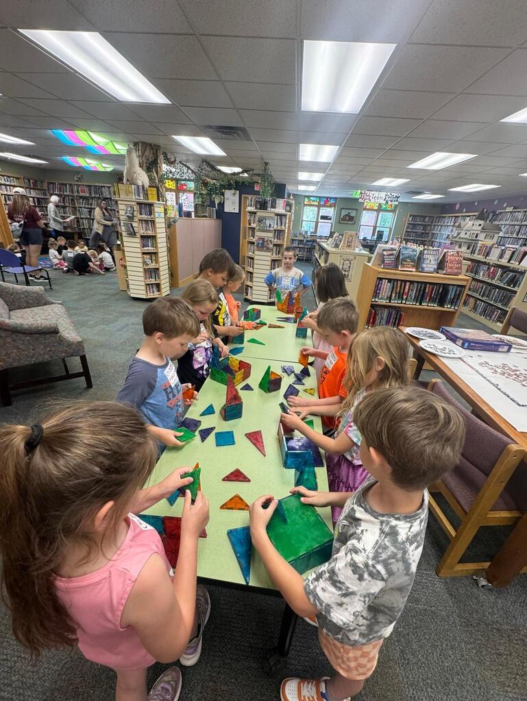 students at the Stair District Library learning about the summer reading program.