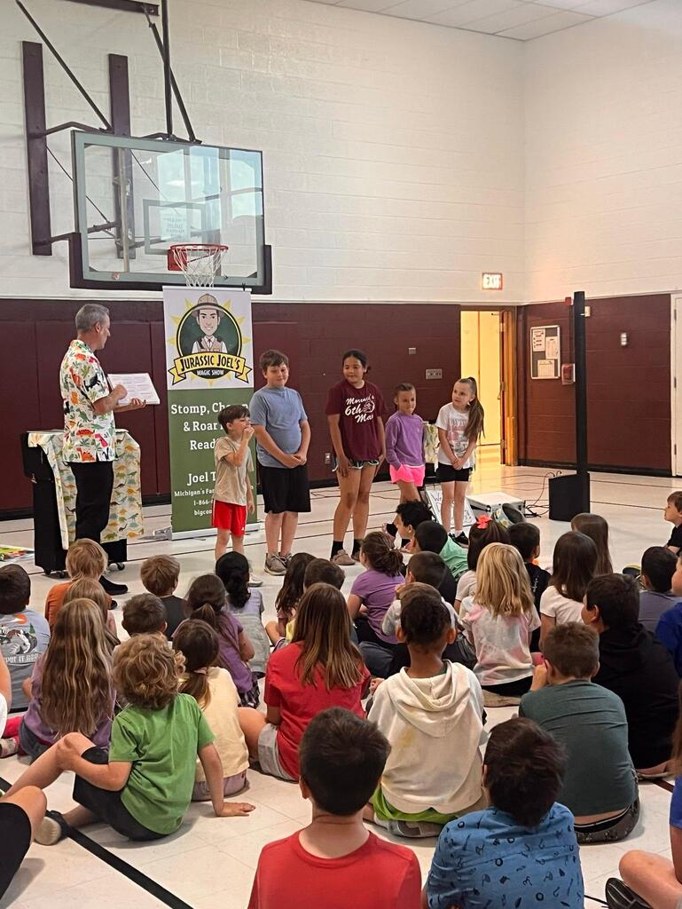 students at the Stair District Library learning about the summer reading program.