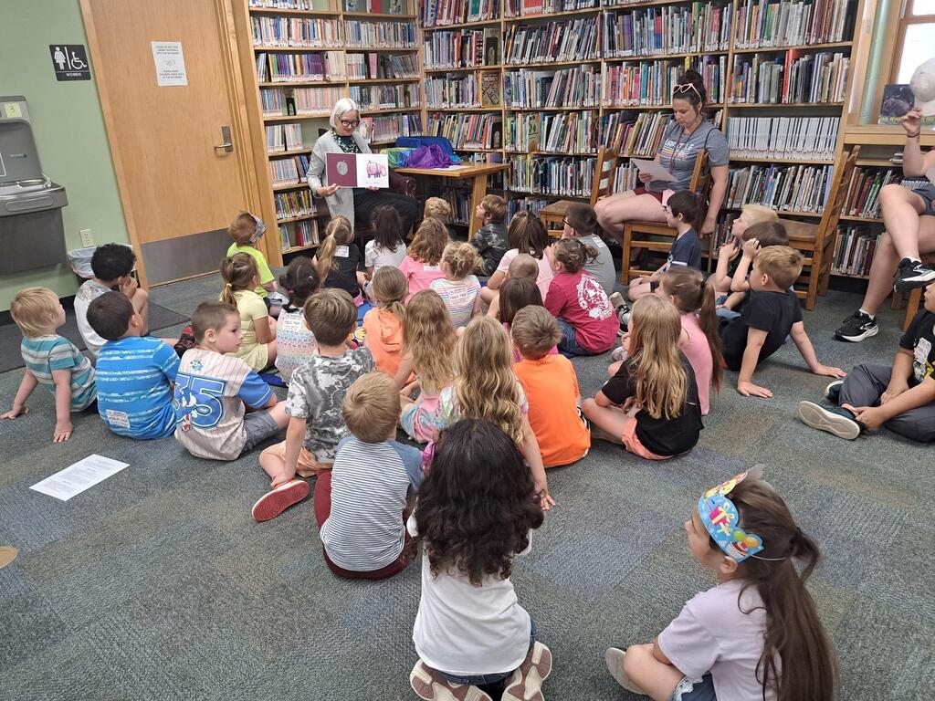 students at the Stair District Library learning about the summer reading program.