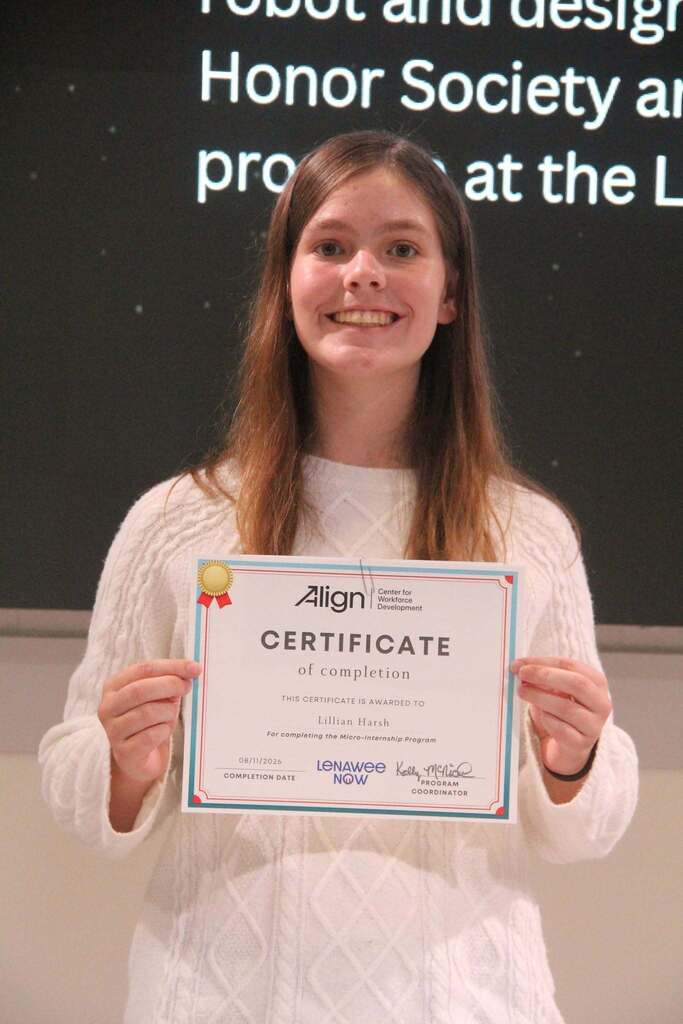 student holding certificate