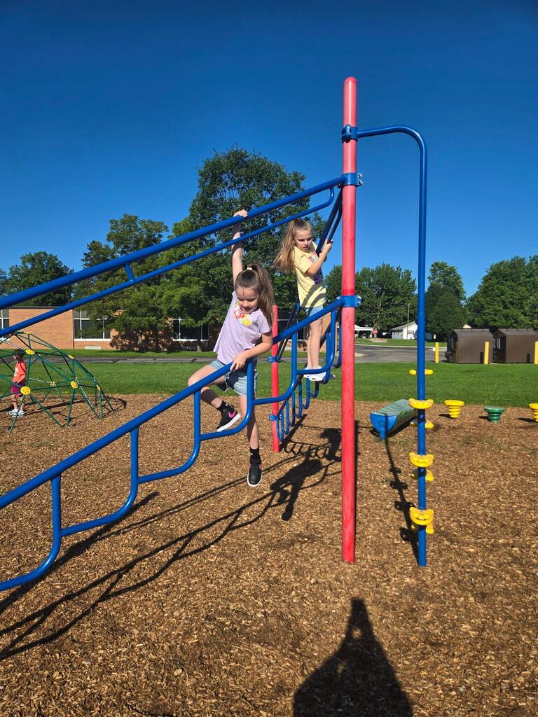 students playing on the playground structure