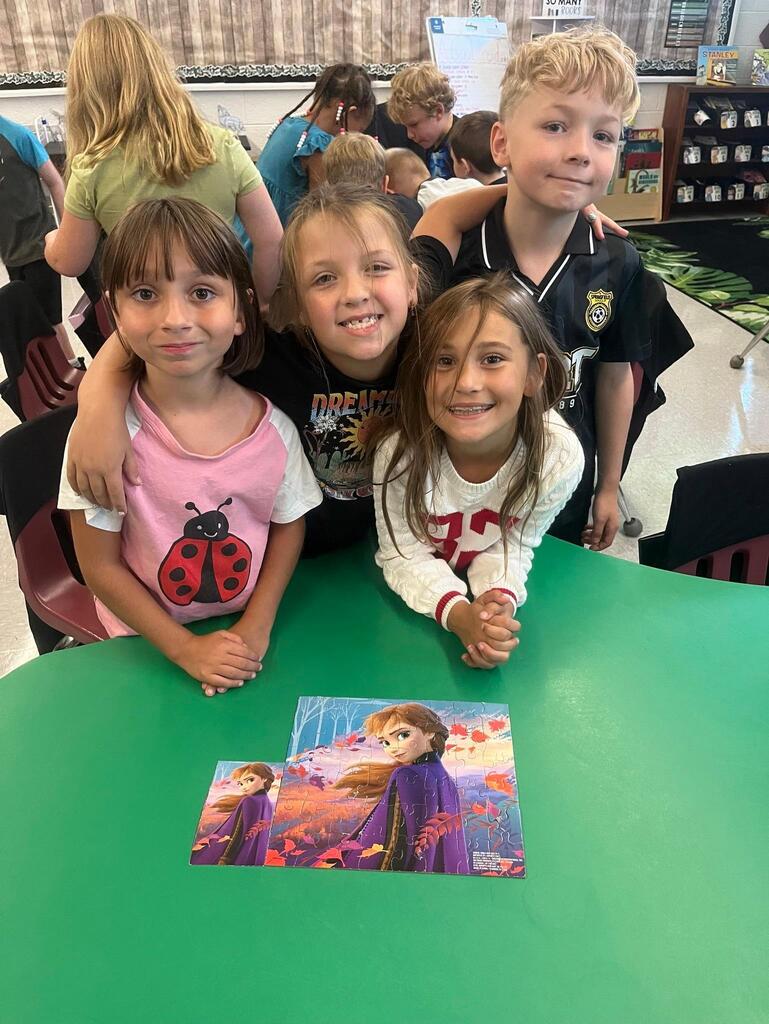 students working on putting a puzzle together