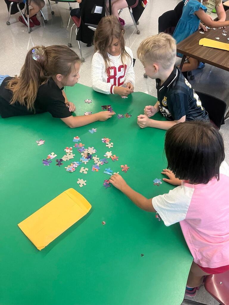 students working on putting a puzzle together