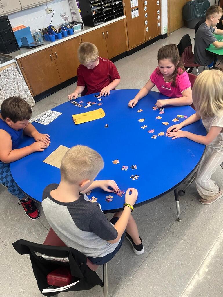 students working on putting a puzzle together