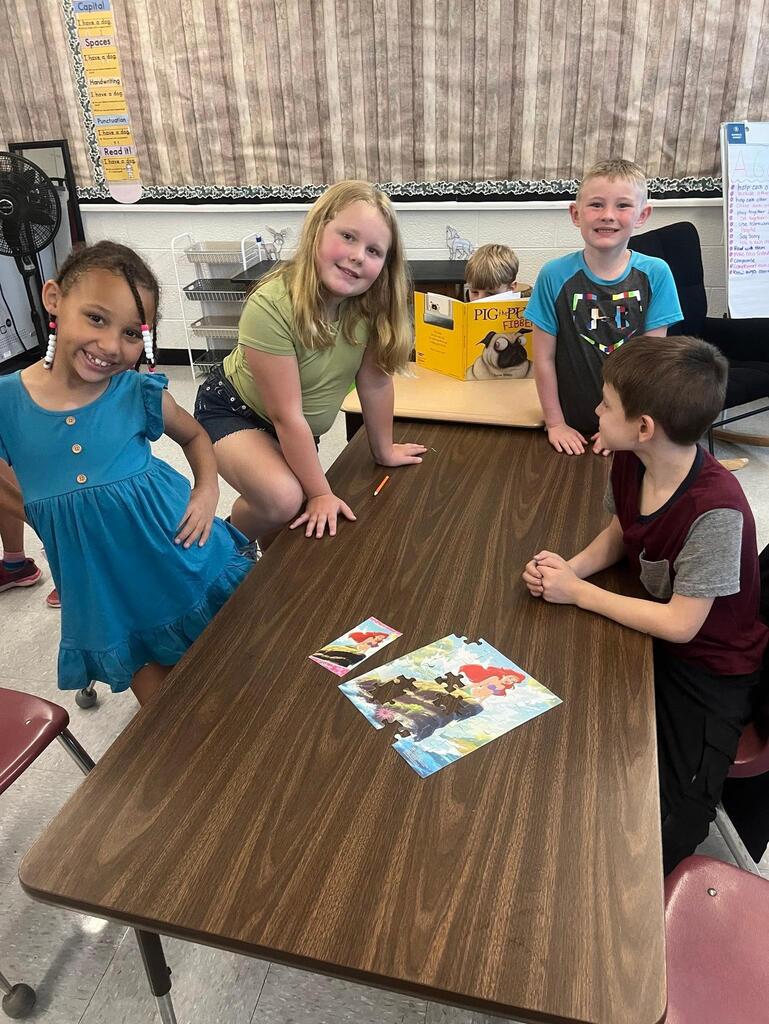 students working on putting a puzzle together