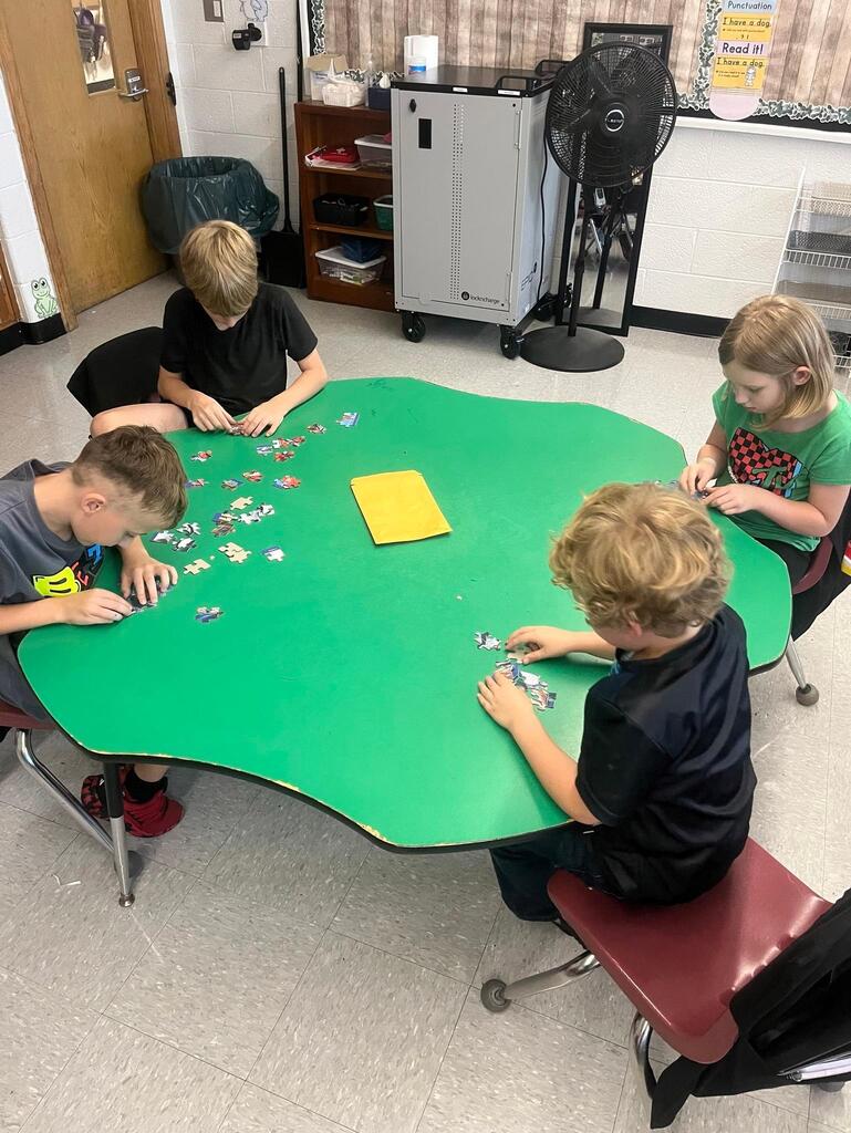 students working on putting a puzzle together