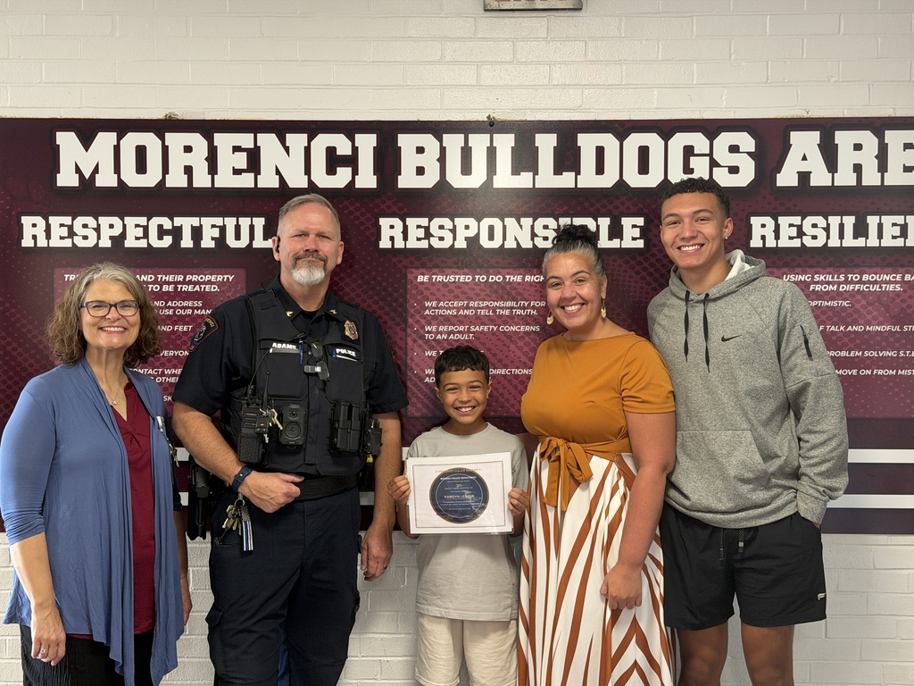 Picture of Student with his mom, teacher and police officer