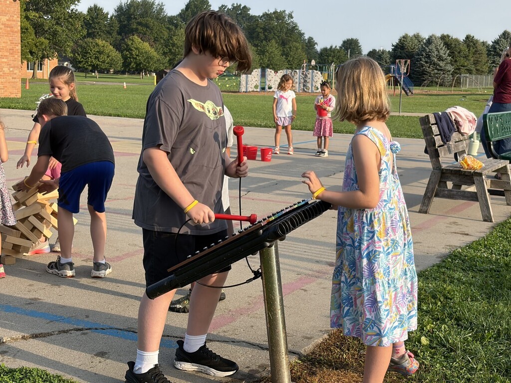 students playing a musical instrument on the playground