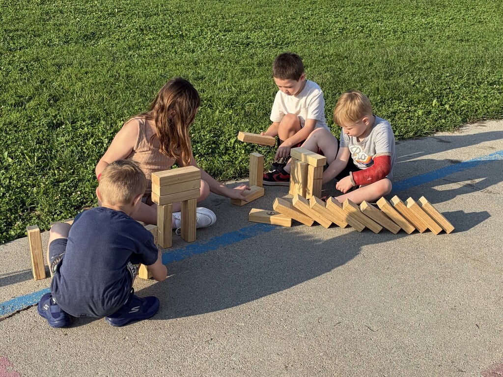 students playing with wood block