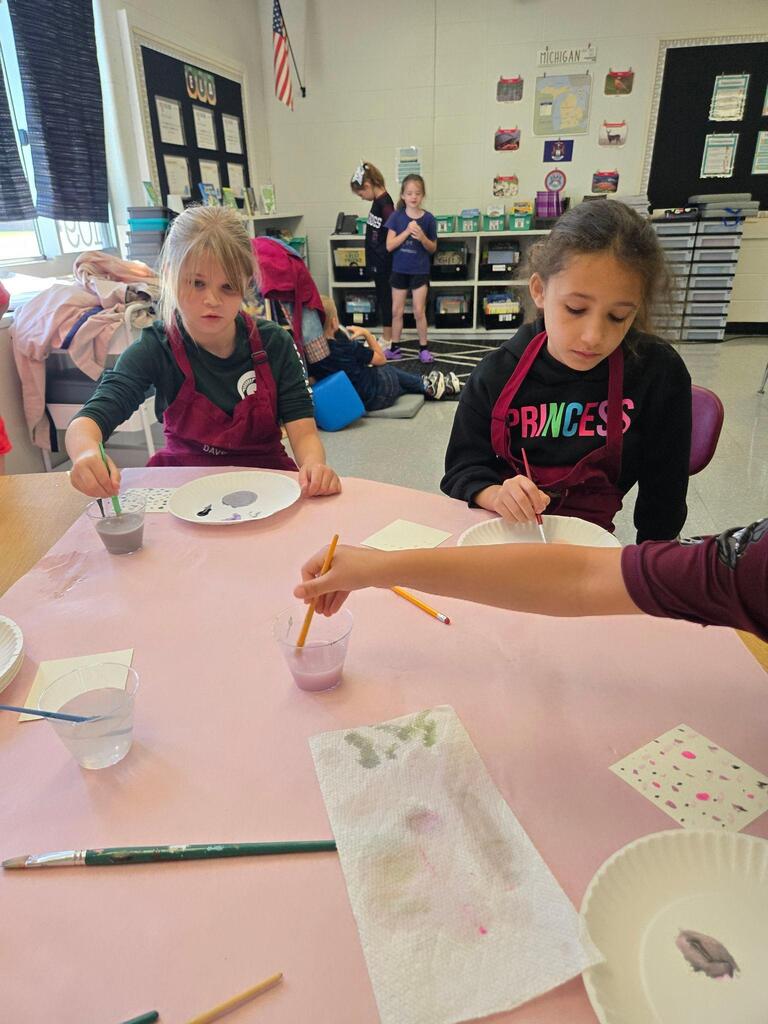 two students working on an art project