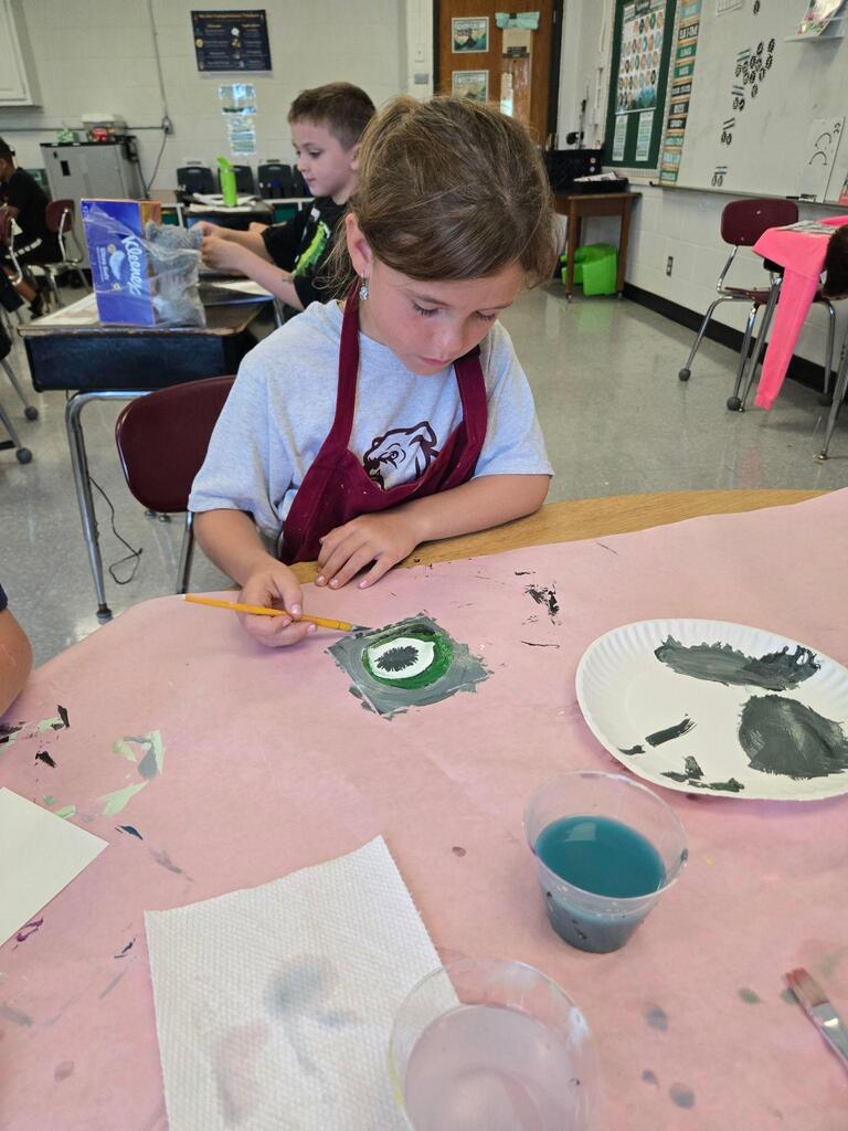 student working on an art project