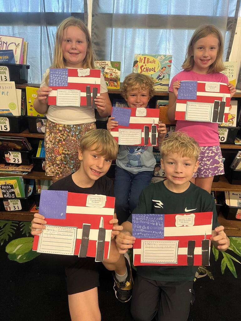five students holding a flag project they did in class.
