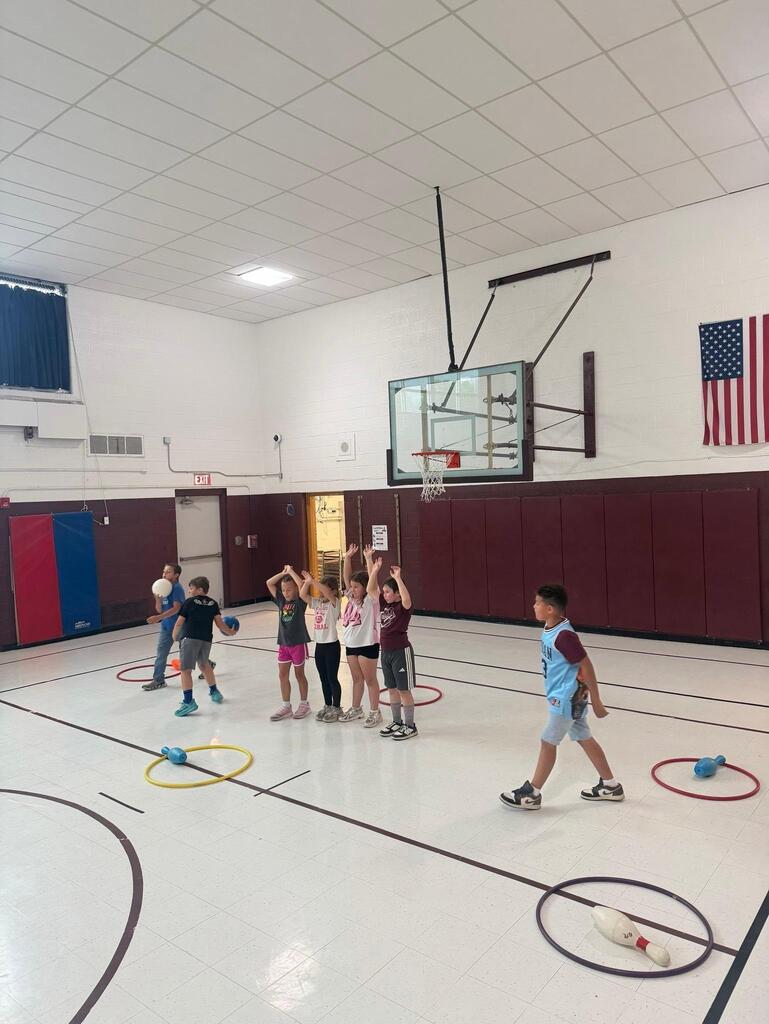 students playing game in gym class