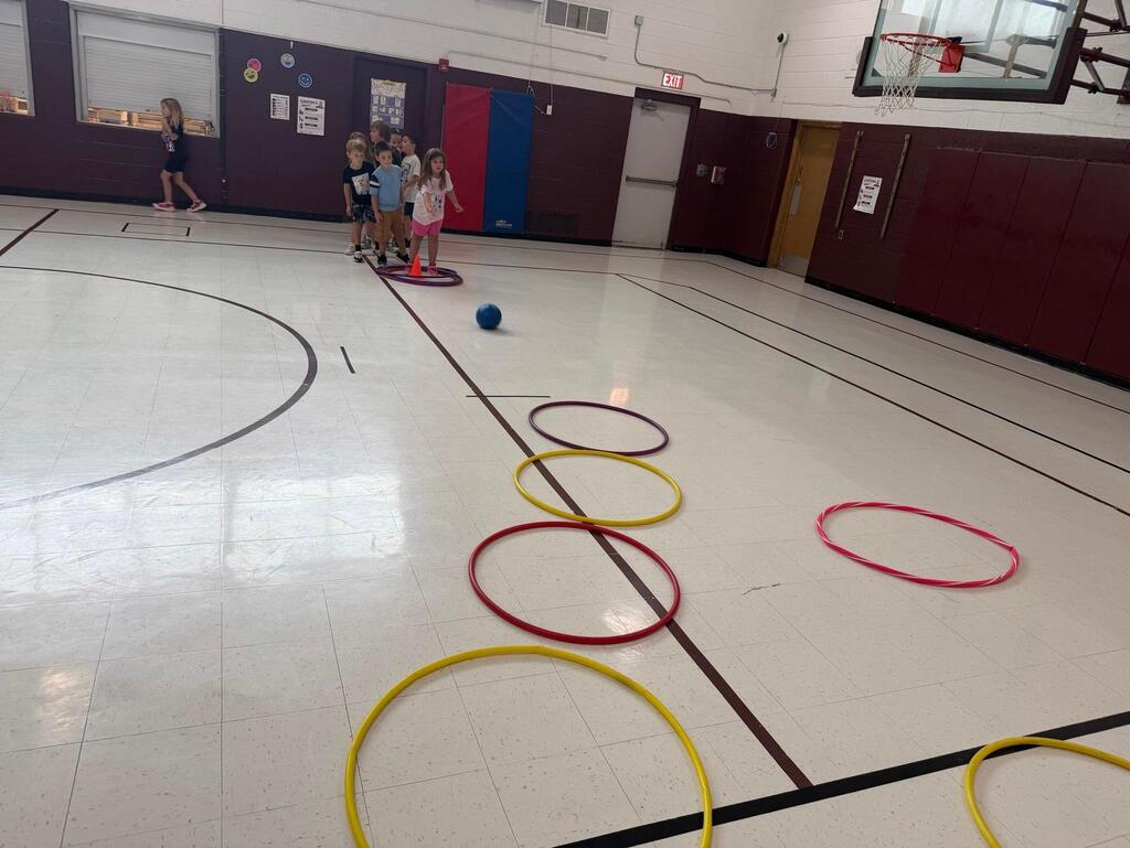 students playing game in gym class