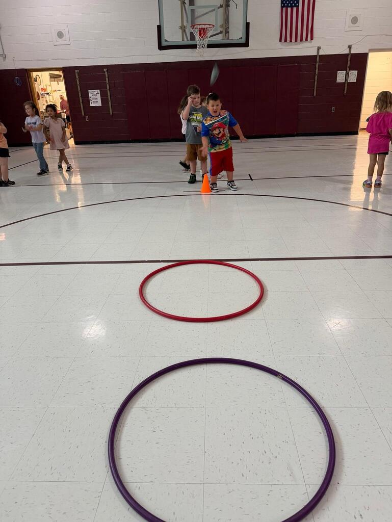 students playing game in gym class