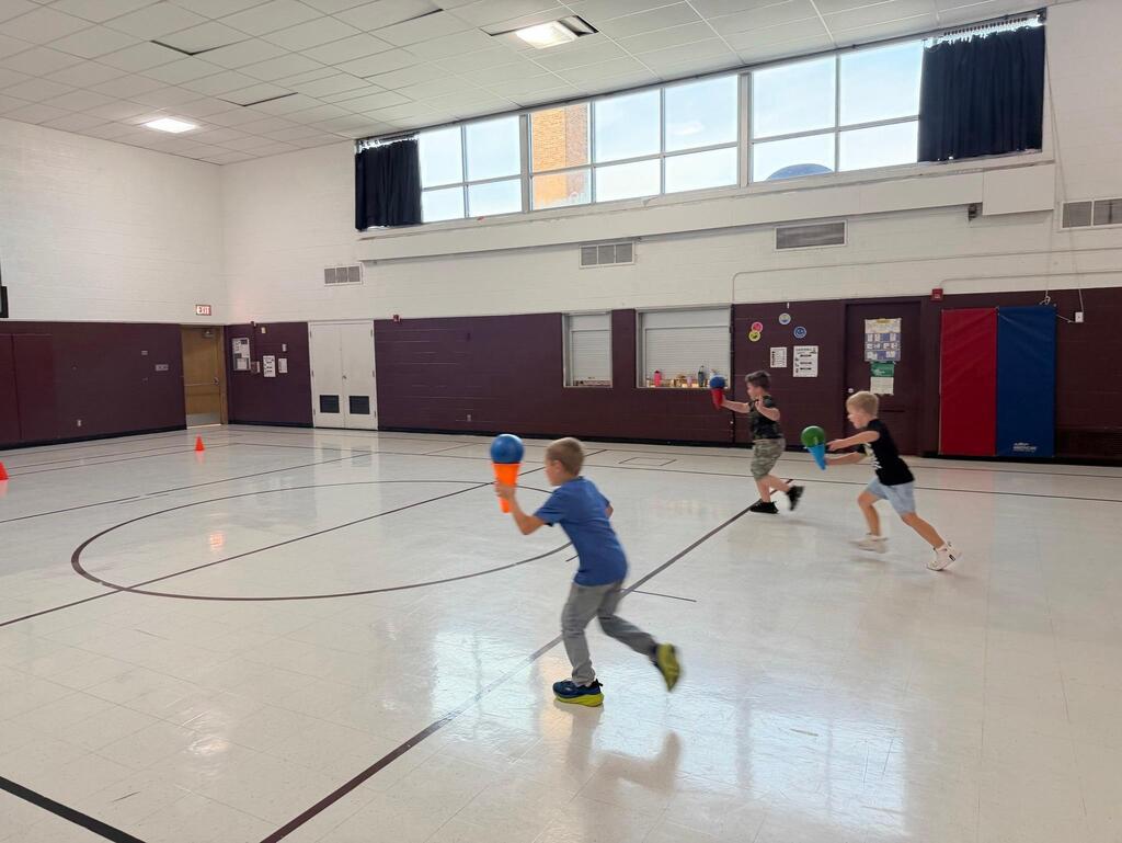 students playing game in gym class
