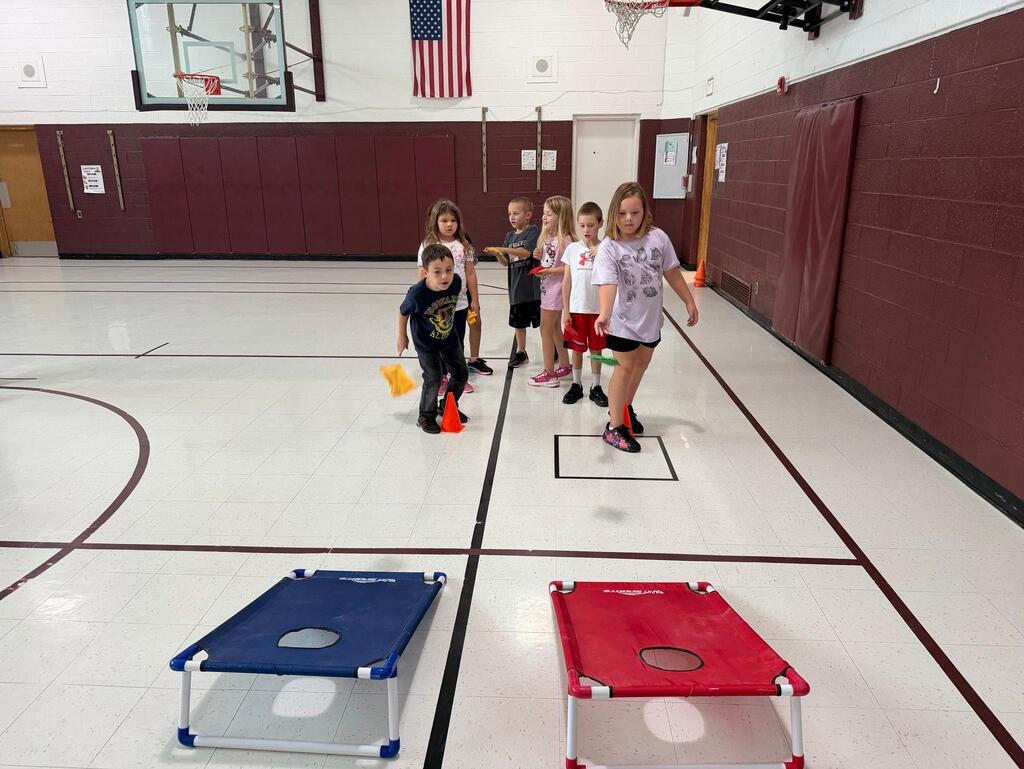 students playing game in gym class