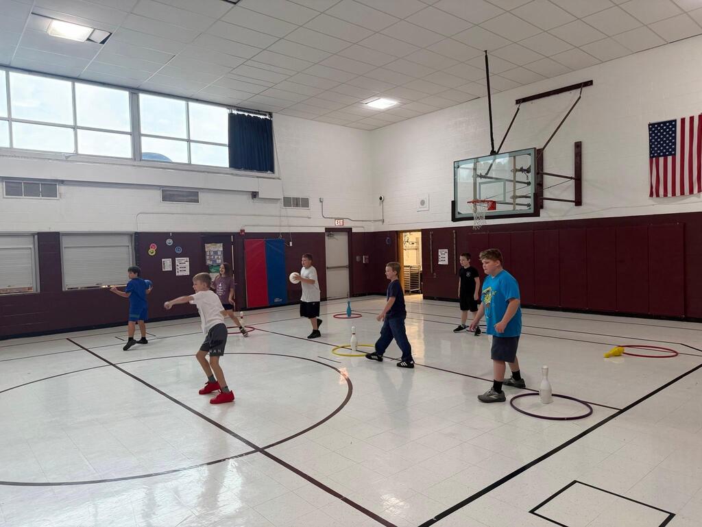 students playing game in gym class