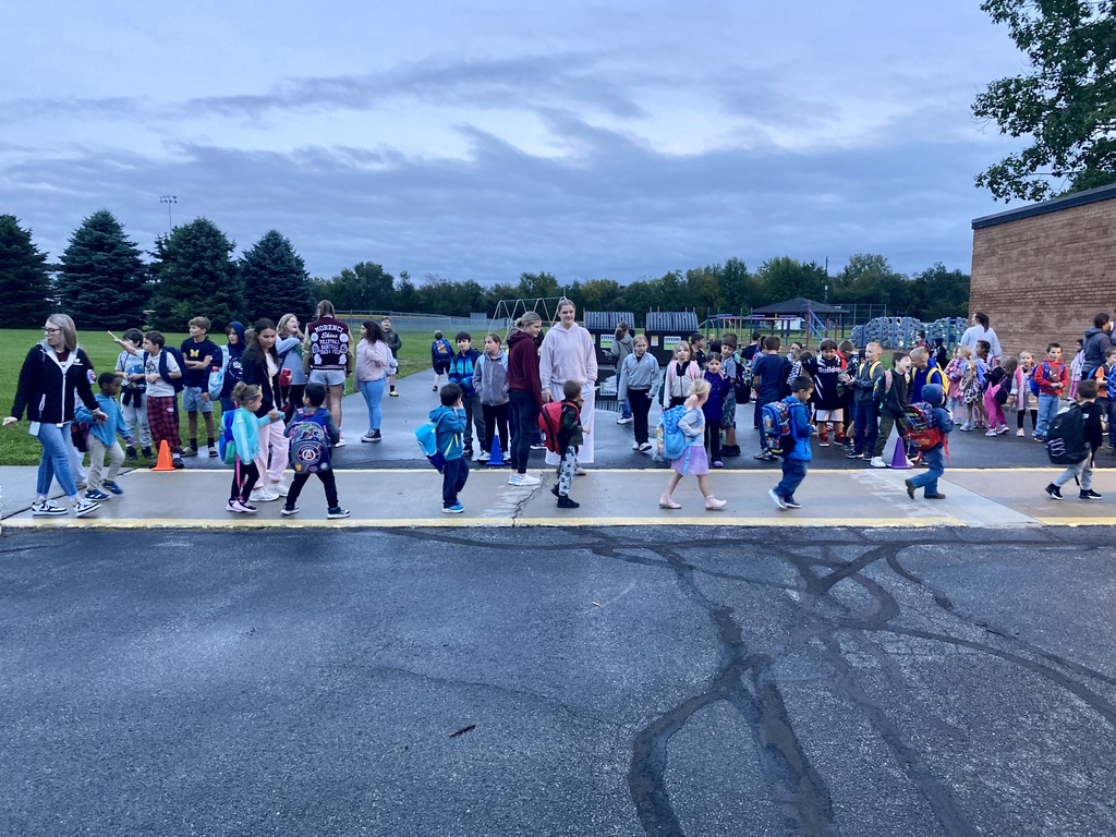 varsity volleyball players greeting the elementary students