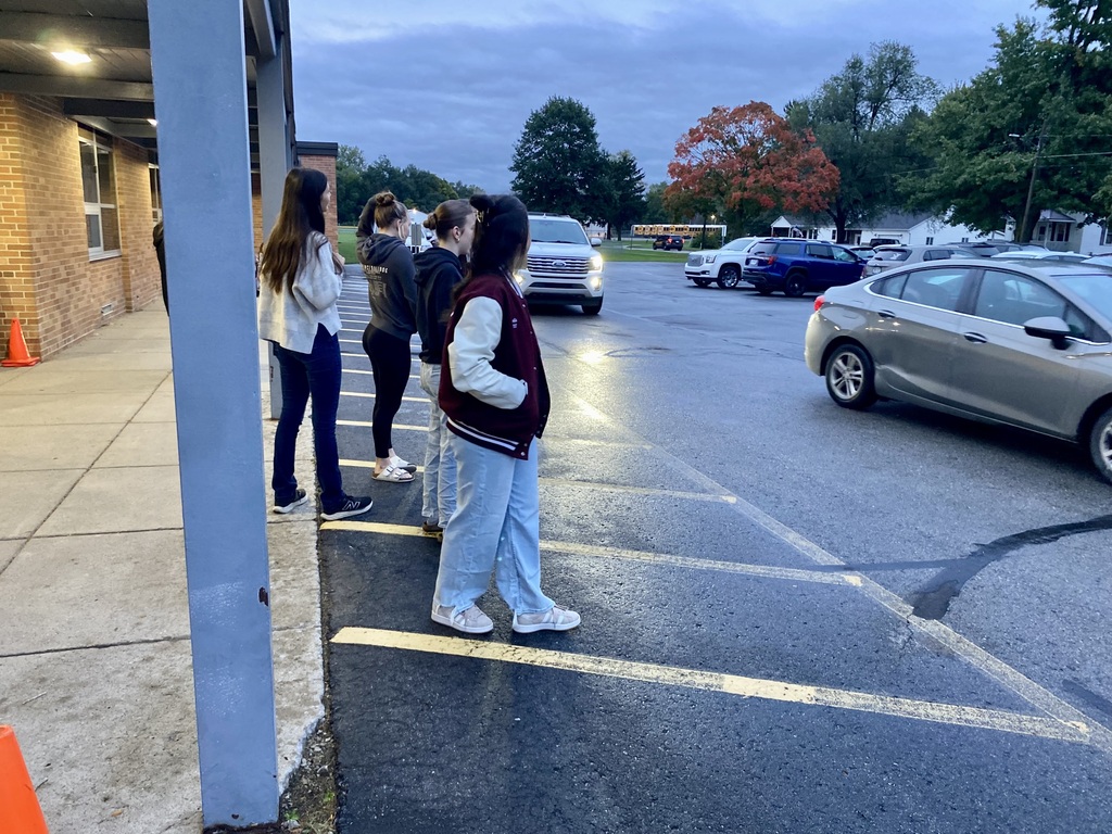 hs students greeting the elementary kids when arriving.