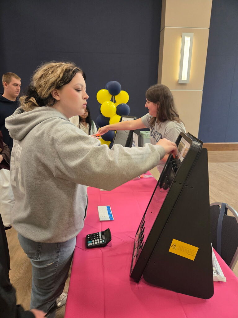 student at a booth