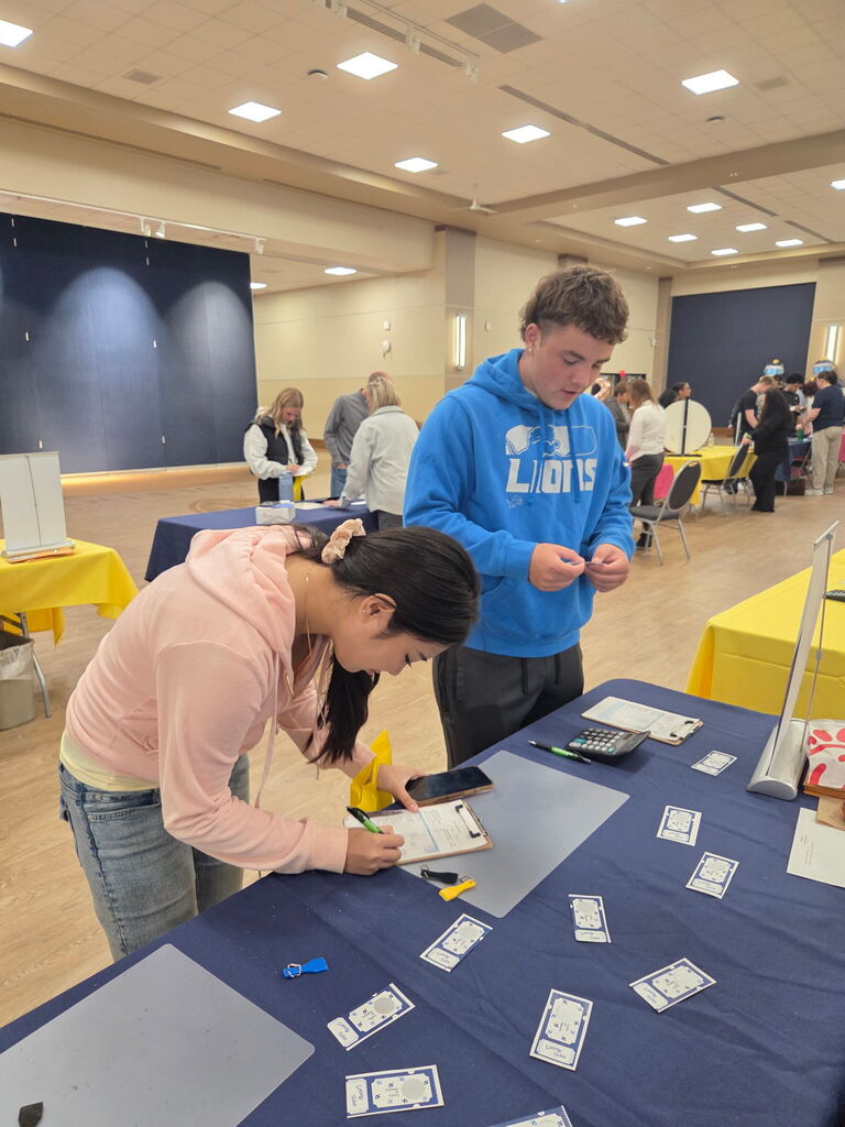 two students at a booth