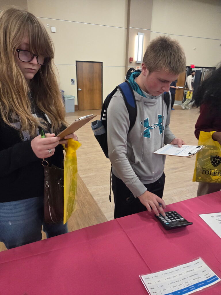 two students sing a calculator
