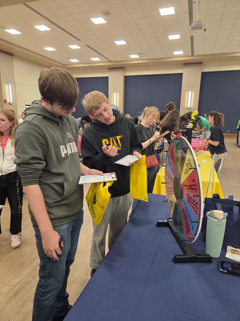 two students spinning a wheel