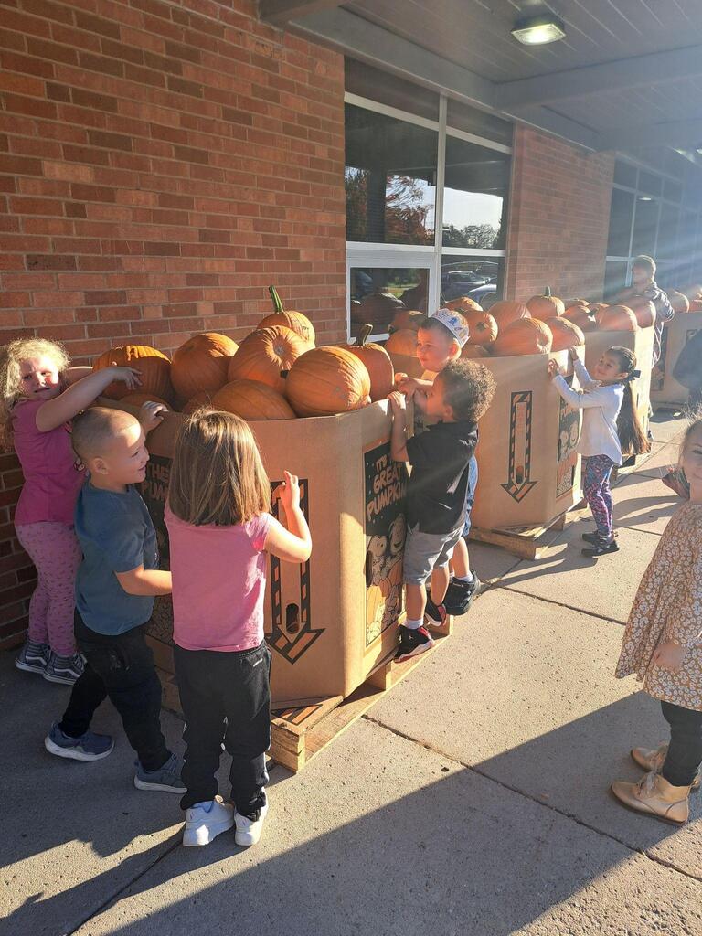 students picking out their pumpkins