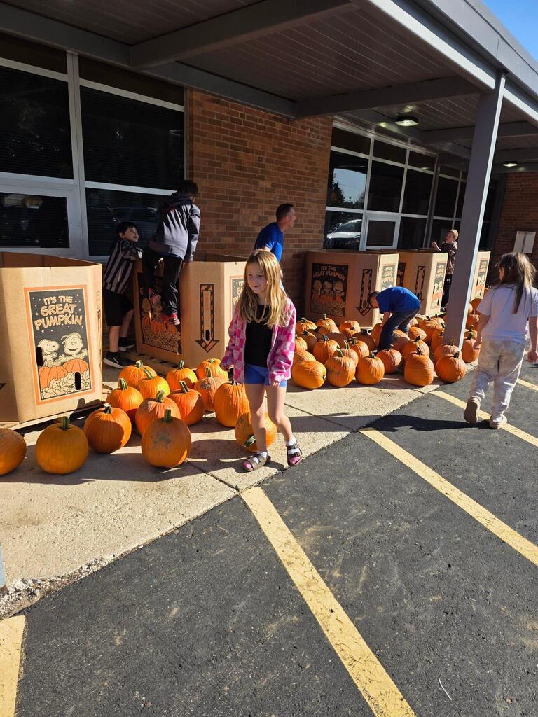 students picking out their pumpkins