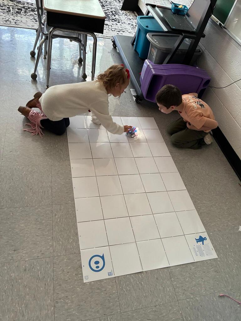 students working on stem project coding bots