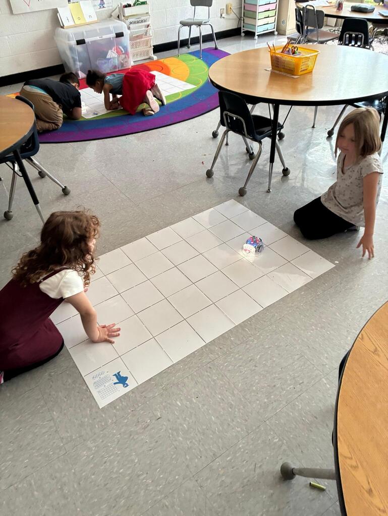 students working on stem project coding bots