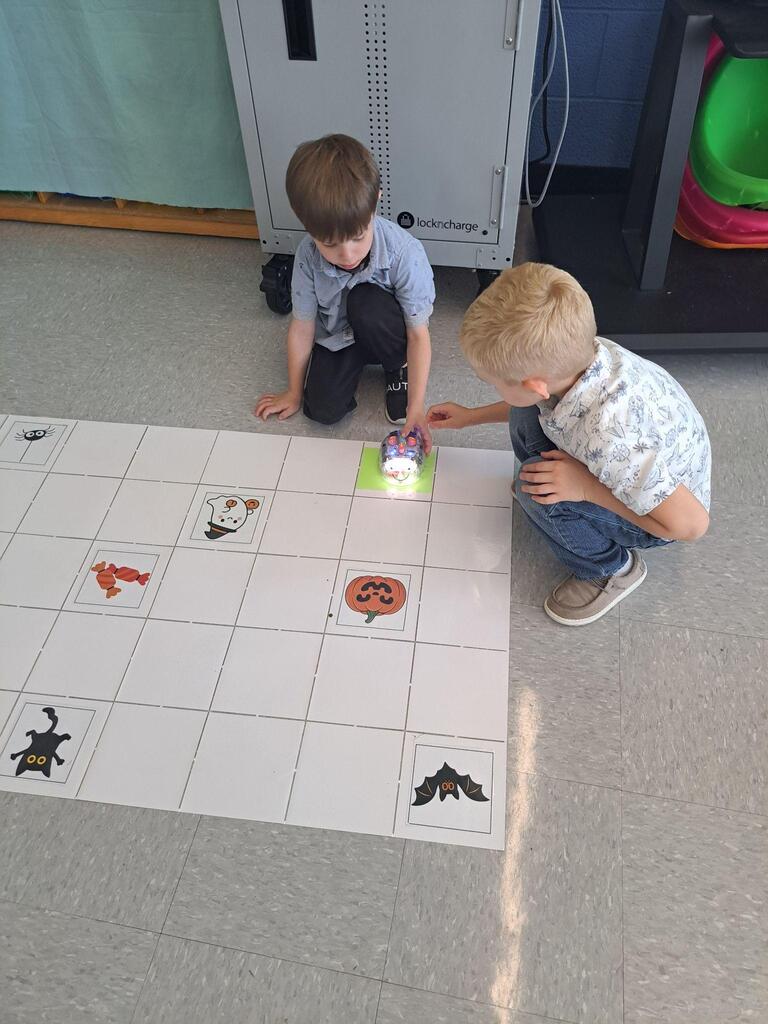 students working on stem project coding bots