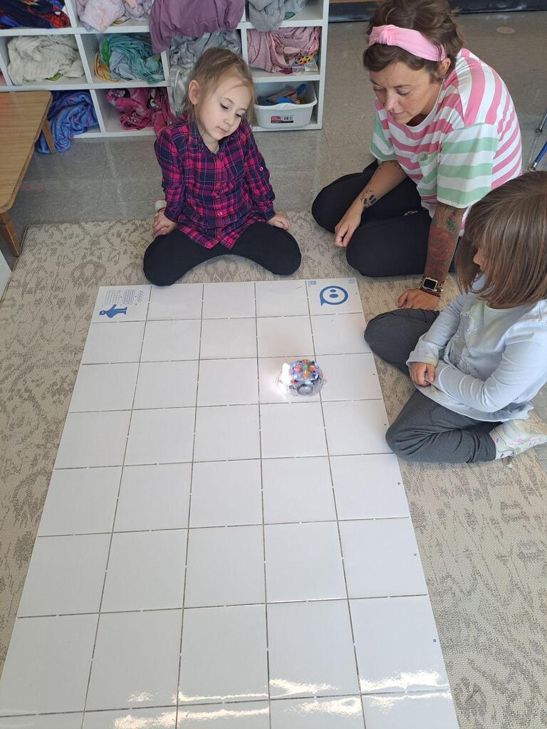 students working on stem project coding bots
