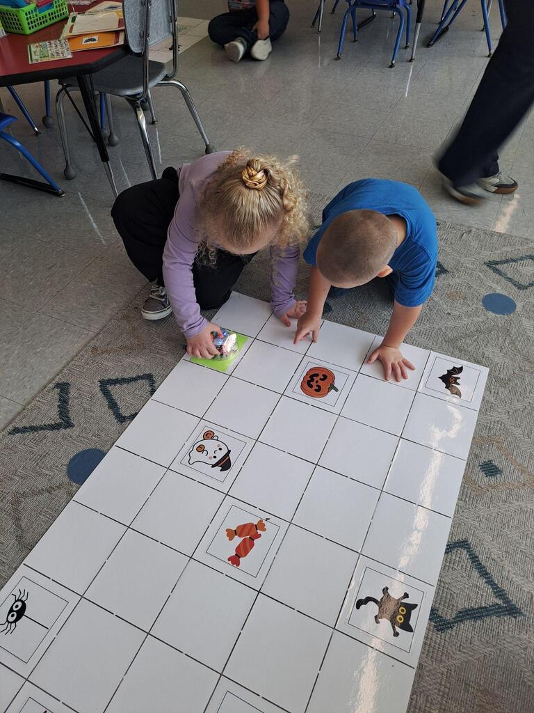 students working on stem project coding bots