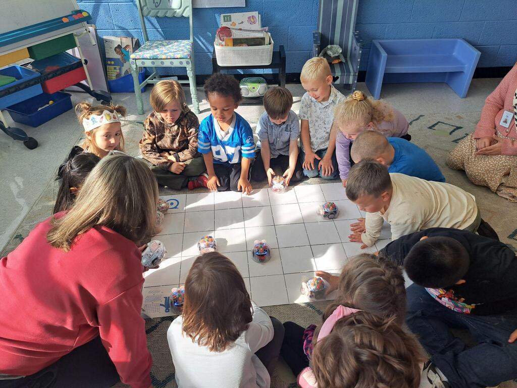 students working on stem project coding bots