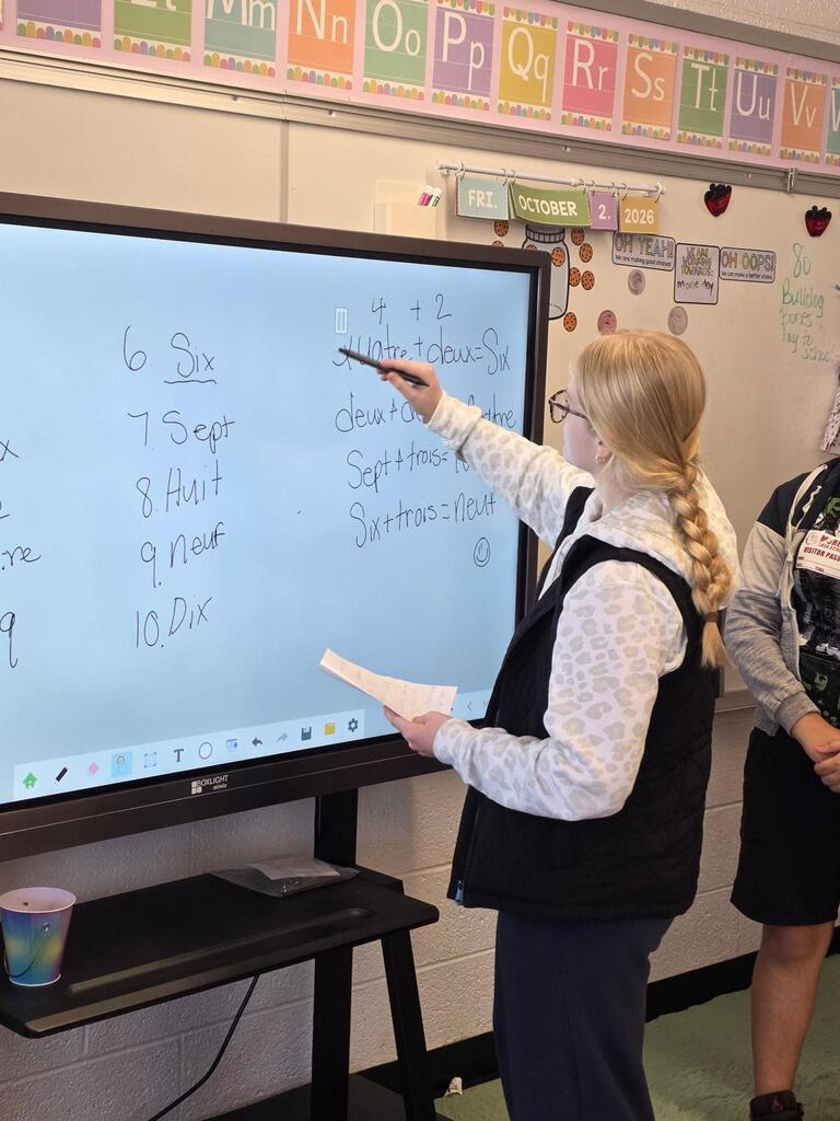 student presenting lesson on smartboard