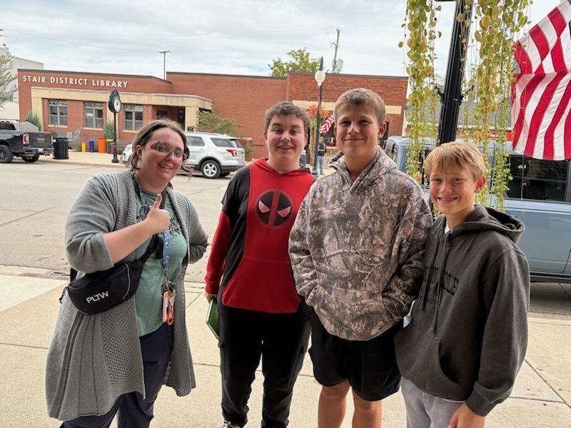 three students and a teacher at the theatre