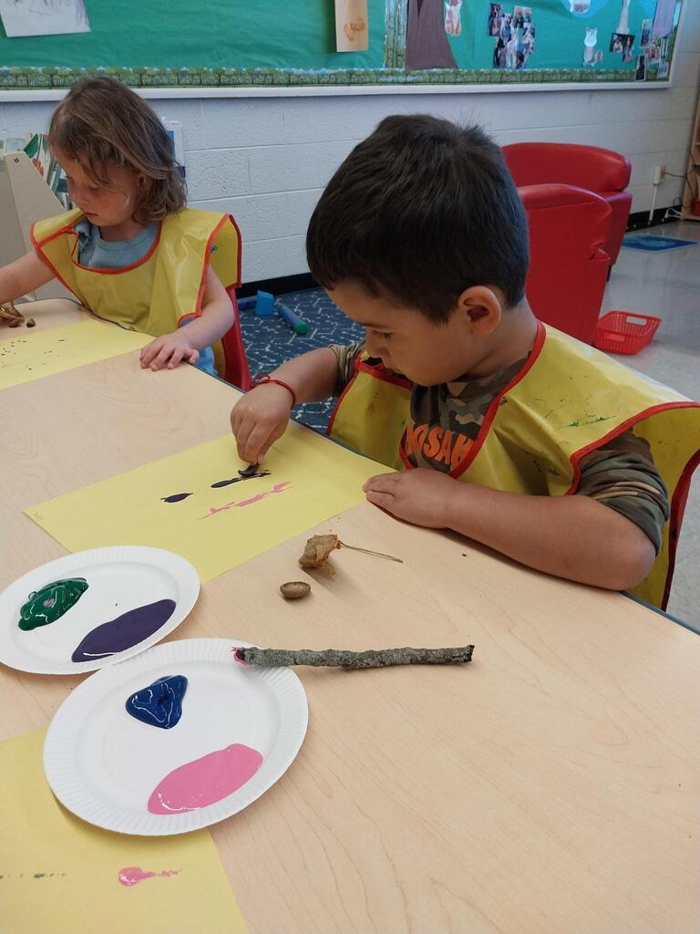 students painting with sticks