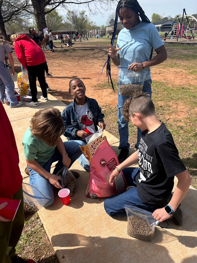 students diving the dog food into packets