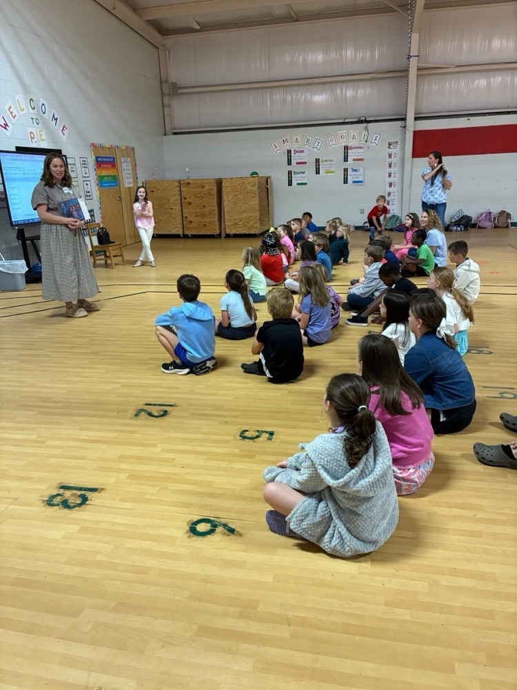 Students listen to a volunteer speak during the optional FCA Huddle.