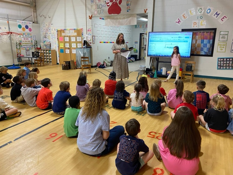 Students listen to a volunteer speak during the optional FCA Huddle.
