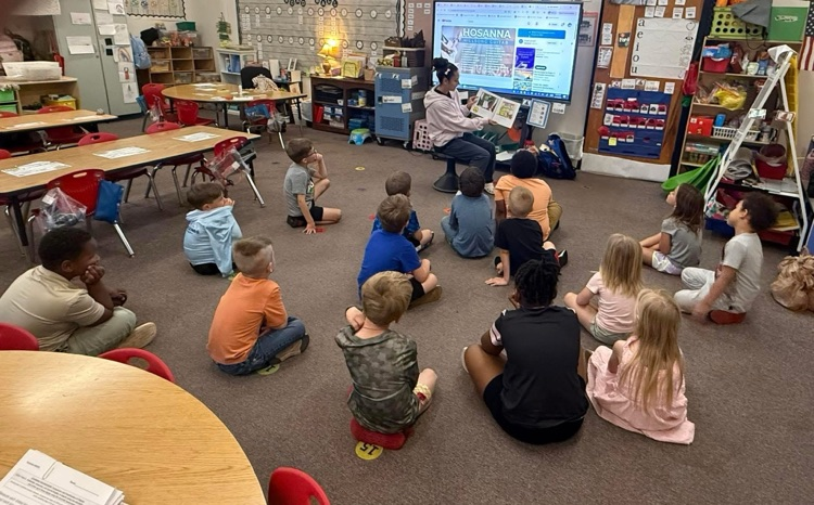 FERST volunteers read the book Bunny Cakes to students  