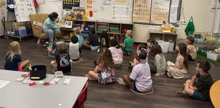 FERST volunteers read the book Bunny Cakes to students. 