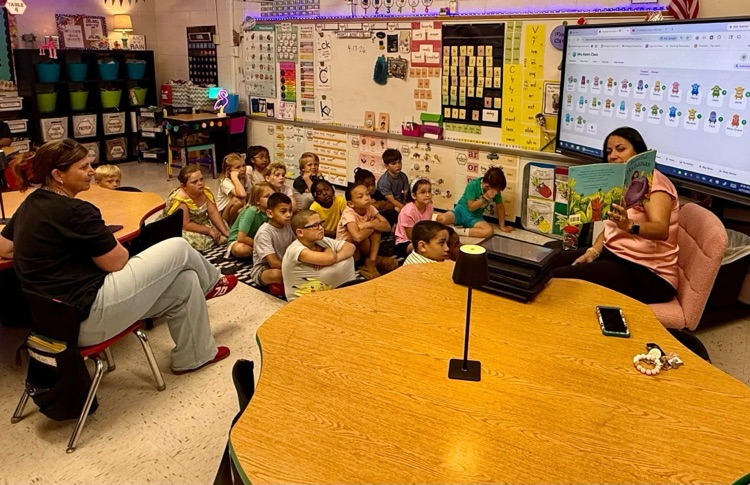 volunteers from the Mayor’s Reading club read aloud to students. 