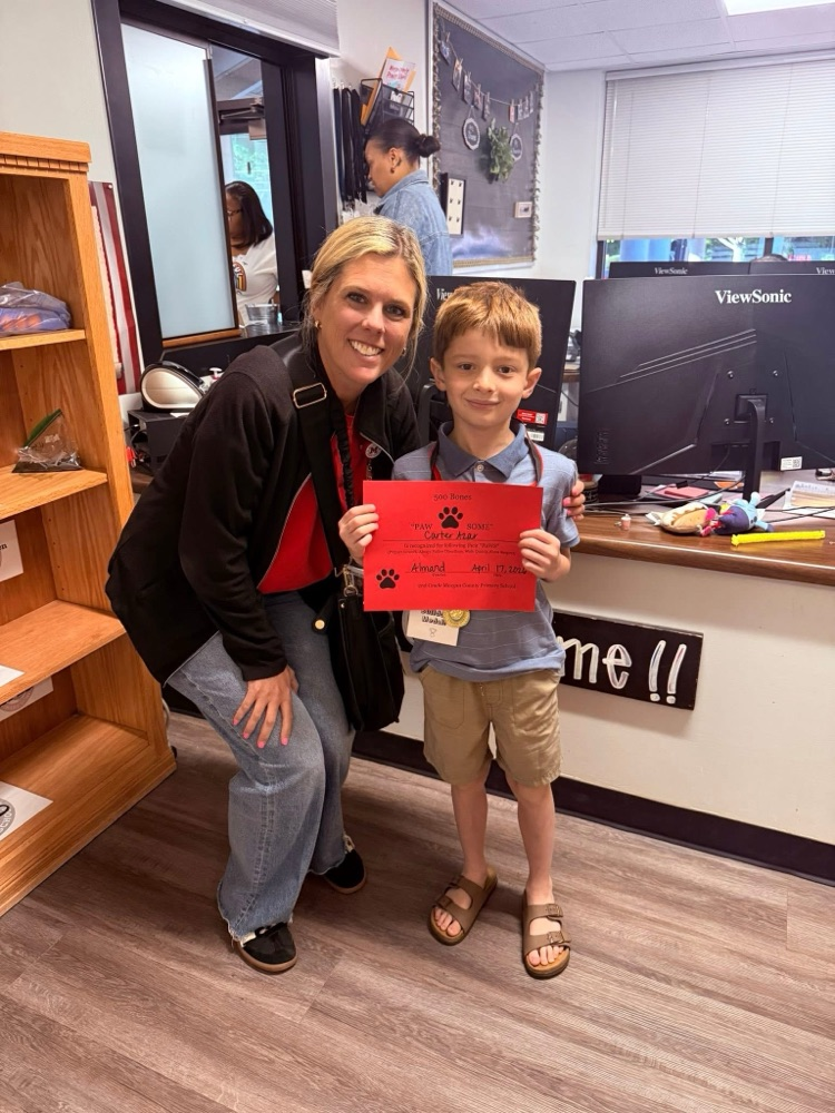 Student earned a medal for earning 500 bones for great behavior.